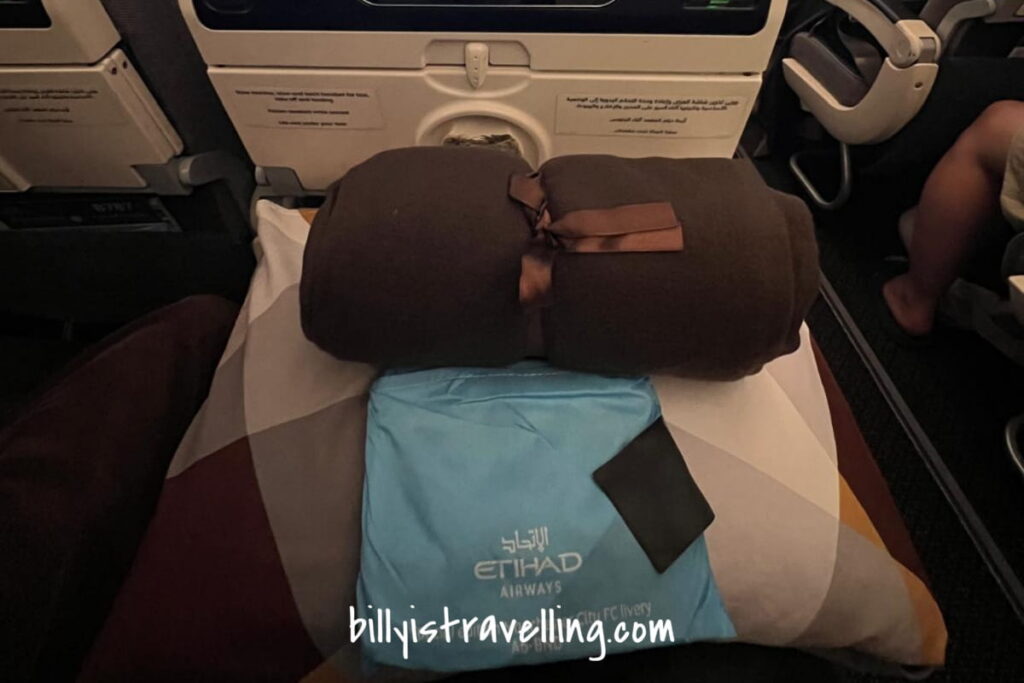Etihad Airways Economy Class amenity kit and blanket
