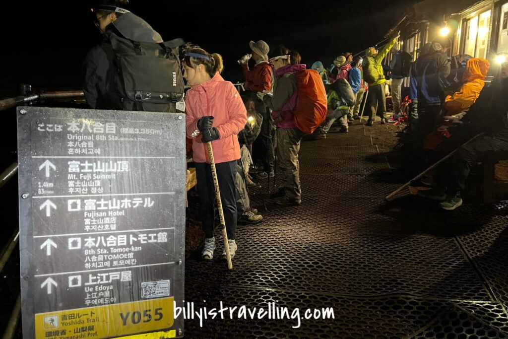 many people hiking  mt fuji at midnight 